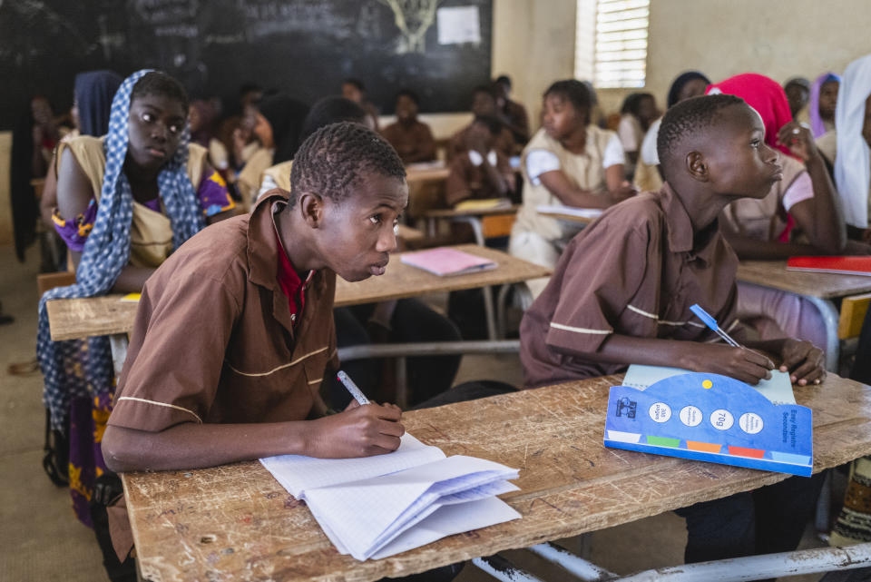 Mouhamed Sall, who is deaf, attends class at the Guinaw Rail Sud public high school in Pikine, Senegal, Monday, March 18, 2024. Sall and three other students are part of a new approach in a small number of schools in Senegal that seat those who are deaf and hard of hearing with the rest of the class. (AP Photo/Sylvain Cherkaoui)