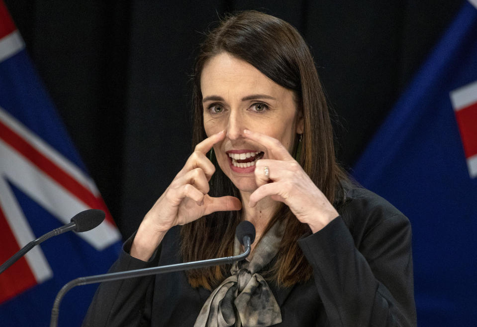 New Zealand Prime Minister Jacinda Ardern gestures during a press conference in Wellington, New Zealand, Wednesday, Aug. 12, 2020. Authorities have found four cases of the coronavirus in one Auckland household from an unknown source, the first reported cases of local transmission in the country in 102 days. The news came as an unpleasant surprise and raised questions about whether the nation's general election would go ahead as planned next month. (Mark Mitchell/New Zealand Herald via AP)