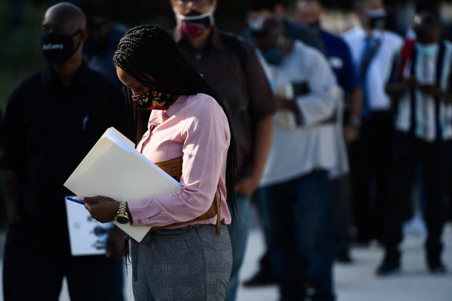 People wait in line to attend a job fair for employment with SoFi Stadium and Los Angeles International Airport employers, at SoFi Stadium on Sept. 9, 2021, in Inglewood, California. (Photo by PATRICK T. FALLON/AFP via Getty Images)