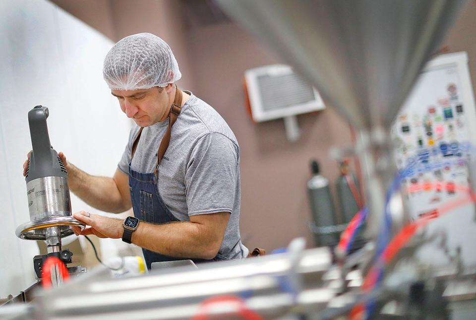 Kevin Burke mixes fermented hot sauce at The Fermentary Taproom in Hanover.