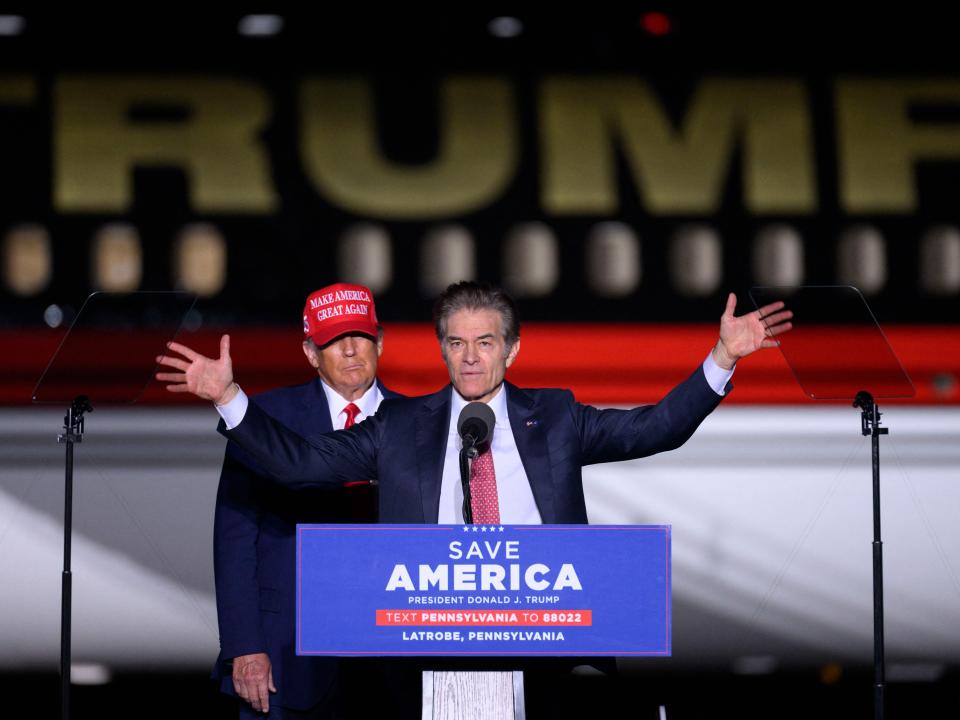 Former US President Donald Trump (L) looks on as Republican Senatorial candidate Mehmet Oz speaks during a "Save America" rally ahead of the midterm elections at Arnold Palmer Regional Airport in Latrobe, Pennsylvania, on November 5, 2022. (Photo by ANGELA WEISS / AFP) (Photo by ANGELA WEISS/AFP via Getty Images)