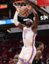 Oklahoma City Thunder forward Luguentz Dort (5) dunks during the first half of an NBA basketball game against the Houston Rockets, Monday, Nov. 29, 2021, in Houston. (AP Photo/Eric Christian Smith)