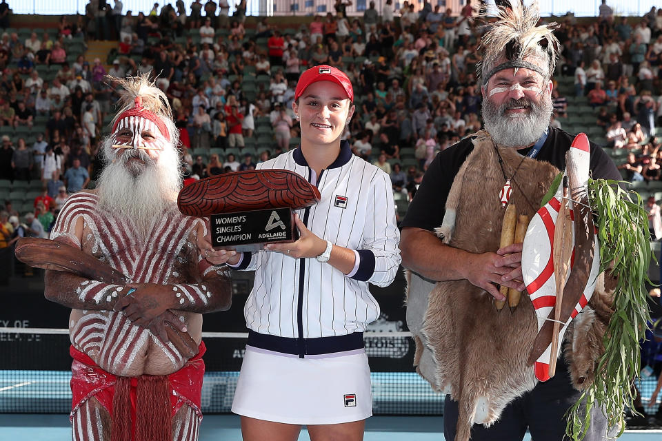 Ash Barty of Australia poses with the trophy together with Aboriginal elders Major Sumner and Mickey Kumatpi O'Brien after winning the women's singles grand final in Adelaide, Australia. (Photo by Paul Kane/Getty Images)