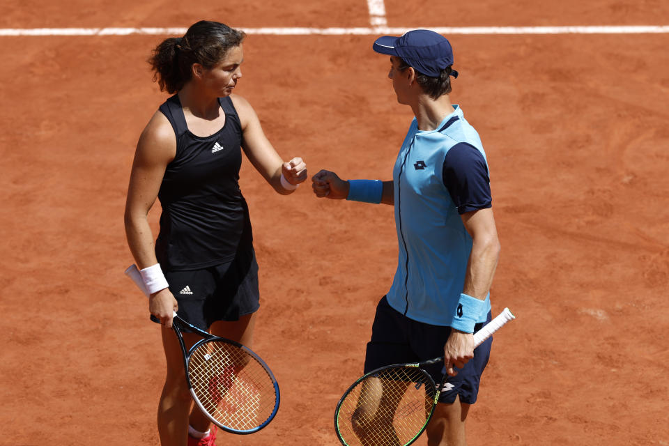 Belgium's Joran Vliegen, right, and Norway's Ulrikke Eikeri check as the play Japan's Ena Shibahara and Netherlands' Wesley Koolhof during their Mixed Doubles final of the French Open tennis tournament at the Roland Garros stadium Thursday, June 2, 2022 in Paris. (AP Photo/Jean-Francois Badias)