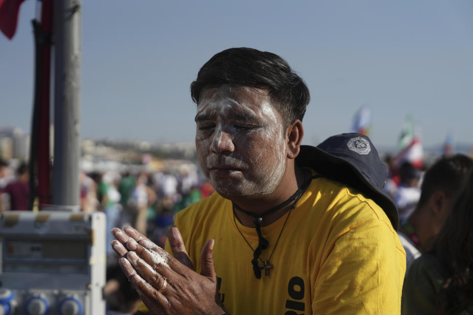 Pilgrims gather at Parque Tejo in Lisbon where Pope Francis is presiding over a mass celebrating the 37th World Youth Day, Sunday, Aug. 6, 2023. An estimated 1.5 million young people filled the parque on Saturday for Pope Francis' World Youth Day vigil, braving scorching heat to secure a spot for the evening prayer and to camp out overnight for his final farewell Mass on Sunday morning. (AP Photo/Ana Brigida)