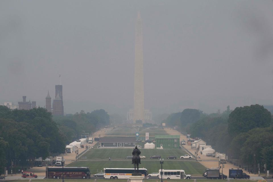 TOPSHOT - The Washington Monument is shrouded in haze as smoke from the Canadian wildfires blankets Washington, DC, on June 7, 2023. A Code Red Air Quality Alert, for unhealthy and unsafe air, is in effect Wednesday for the Washington area (Photo by Jim WATSON / AFP) (Photo by JIM WATSON/AFP via Getty Images)