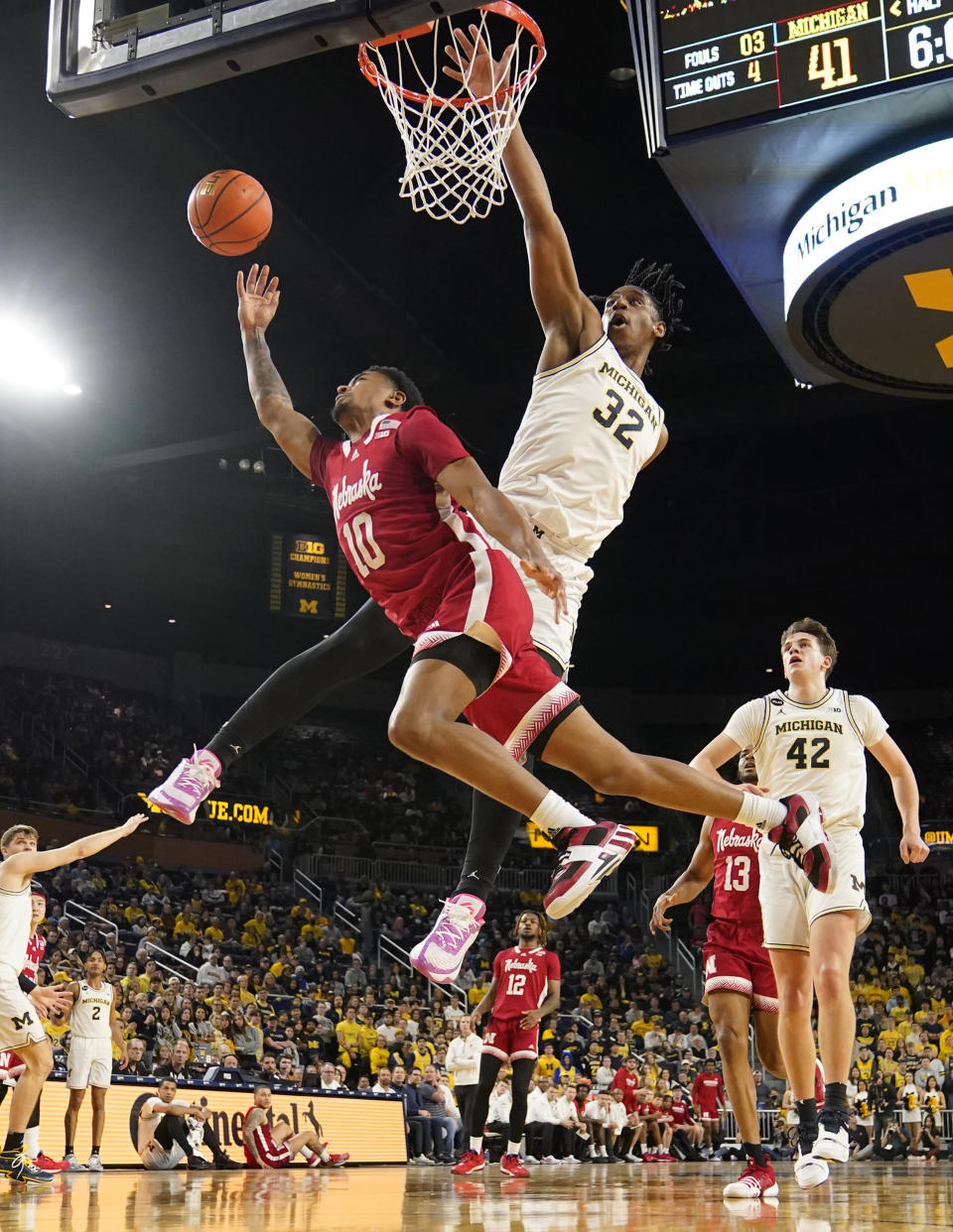 Nebraska guard Jamarques Lawrence (10) attempts a layup as Michigan forward Tarris Reed Jr. (32) defends during the first half of an NCAA college basketball game, Wednesday, Feb. 8, 2023, in Ann Arbor, Mich. (AP Photo/Carlos Osorio)