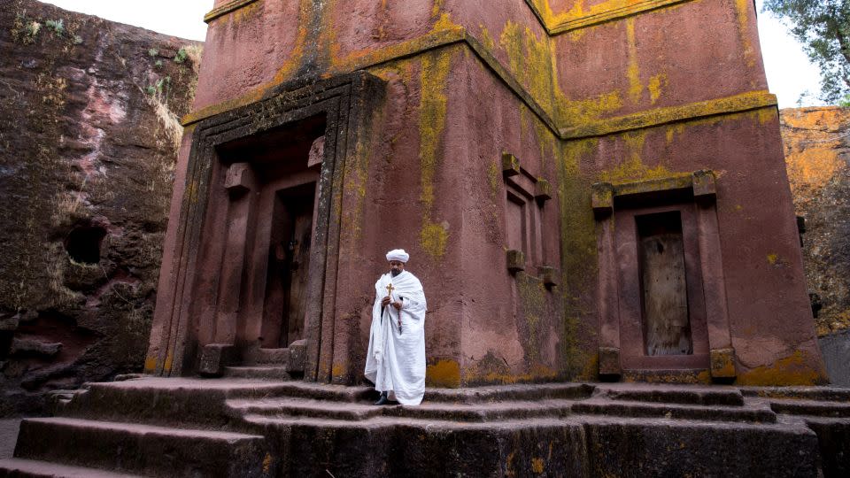 Ninson has traveled around Africa, capturing images including this one, of a priest in front of one of the famed Lalibela churches in Ethiopia. - Paul Ninson