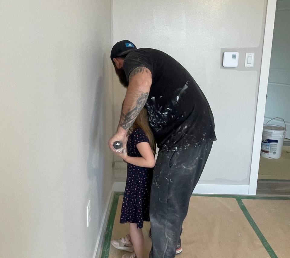 A former professional painter, Alex Doyle teaches his daughter to paint as they get their new home from Habitat for Humanity ready to go.