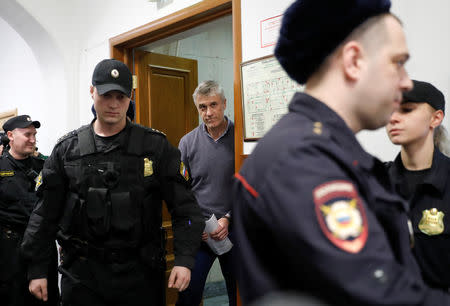 Founder of the Baring Vostok private equity group Michael Calvey, who was detained on suspicion of fraud, is escorted inside a court building in Moscow, Russia February 15, 2019. REUTERS/Tatyana Makeyeva