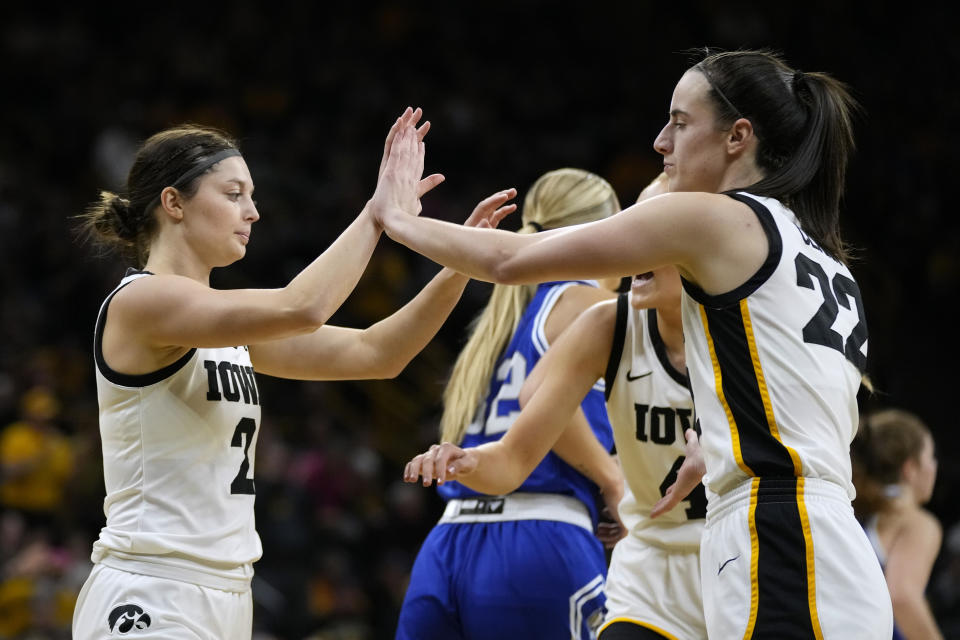 Iowa guard Taylor McCabe (2) celebrates with teammate guard Caitlin Clark (22) after making a 3-point basket during the first half of an NCAA college basketball game against Drake, Sunday, Nov. 19, 2023, in Iowa City, Iowa. (AP Photo/Charlie Neibergall)