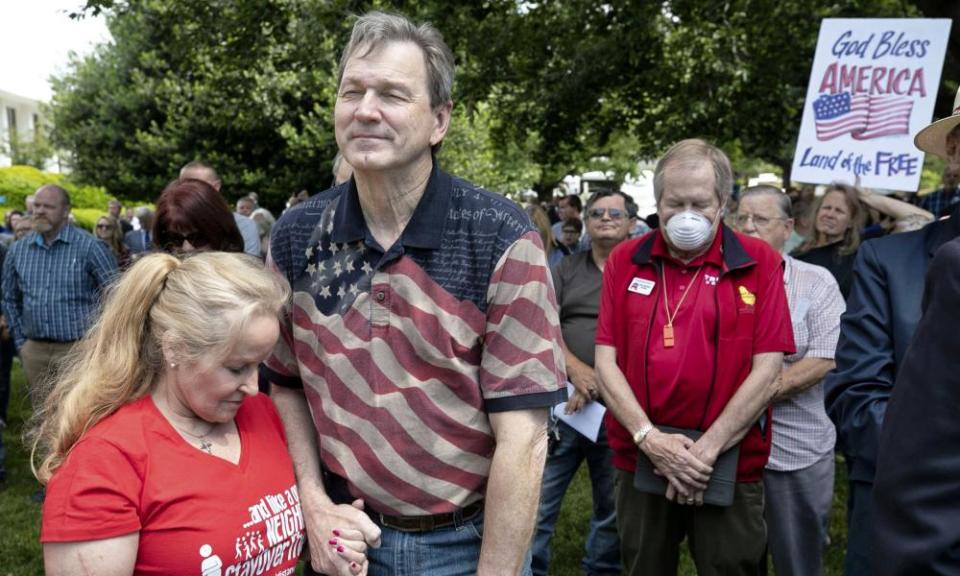 Jim Womack, now chair of the North Carolina Election Integrity Team and his wife, Sherry, pray on the legislative grounds in Raleigh in May 2020.