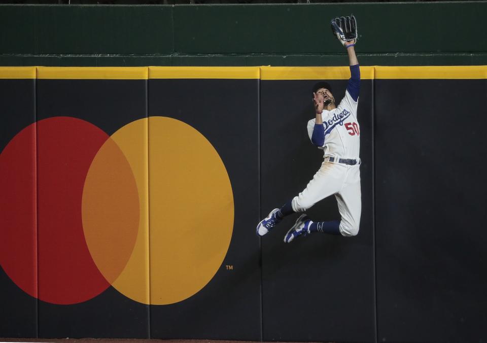 Mookie Betts makes a spectacular leap against the wall to catch a ball.