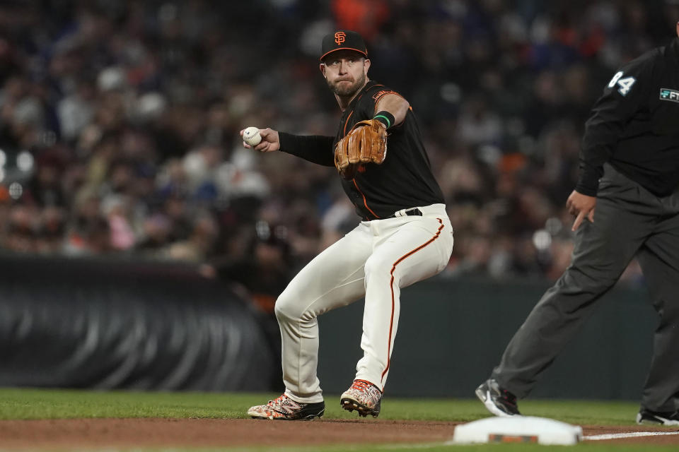 San Francisco Giants third baseman Evan Longoria throws out Los Angeles Dodgers' Justin Turner at first base during the seventh inning of a baseball game in San Francisco, Saturday, Sept. 17, 2022. (AP Photo/Jeff Chiu)