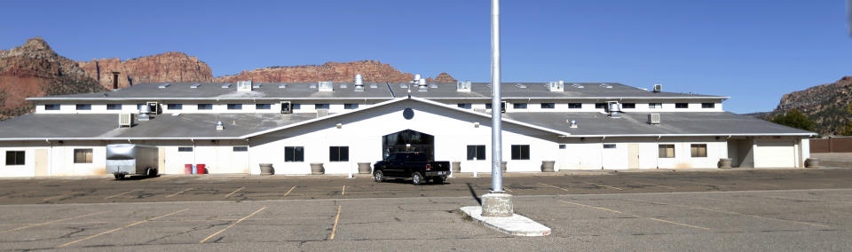 This Oct. 25, 2017, photo shows a meetinghouse in Colorado City, Ariz. A polygamous group known as the Fundamentalist Church of Jesus Christ of Latter Day Saints, or FLDS, is letting go of the sprawling building where its members worshipped, in the latest sign that the sect run by imprisoned leader Warren Jeffs is crumbling and losing control of the community it ruled for a century. (AP Photo/Rick Bowmer)