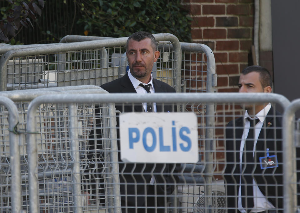 Seen behind barriers blocking the road leading to Saudi Arabia's consulate, security guards stand in Istanbul, Friday, Oct. 26, 2018. The Saudi officials who killed journalist Jamal Khashoggi in their Istanbul consulate must reveal the location of his body, Turkey's President Recep Tayyip Erdogan said Friday in remarks that were sharply critical of the kingdom's handling of the case.(AP Photo/Lefteris Pitarakis)