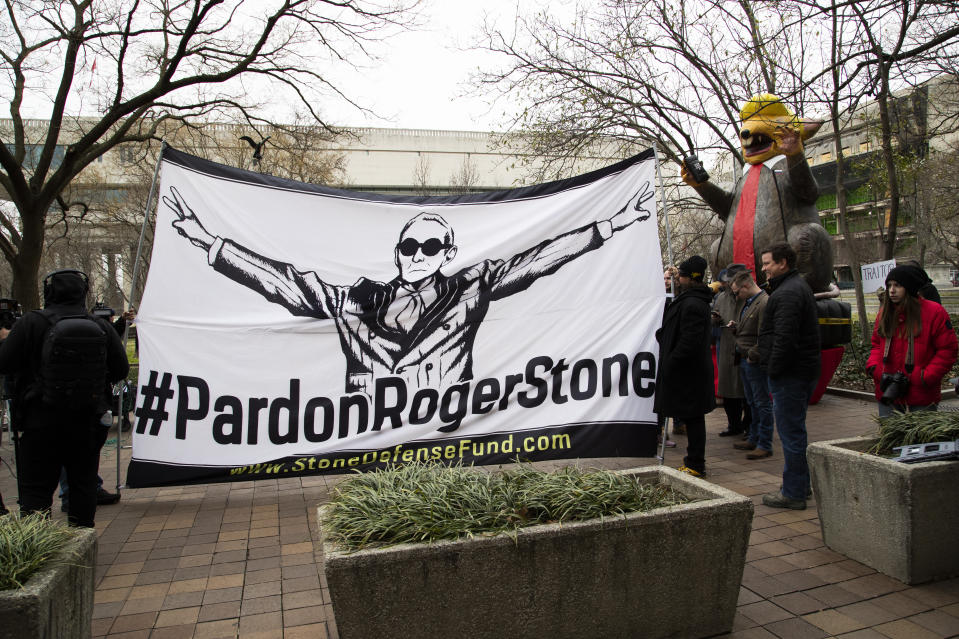 Supporters of Roger Stone with a banner that reads "#PardonRogerStone" wait outside federal court in Washington, Thursday, Feb. 20, 2020.  (Manuel Balce Ceneta/AP)