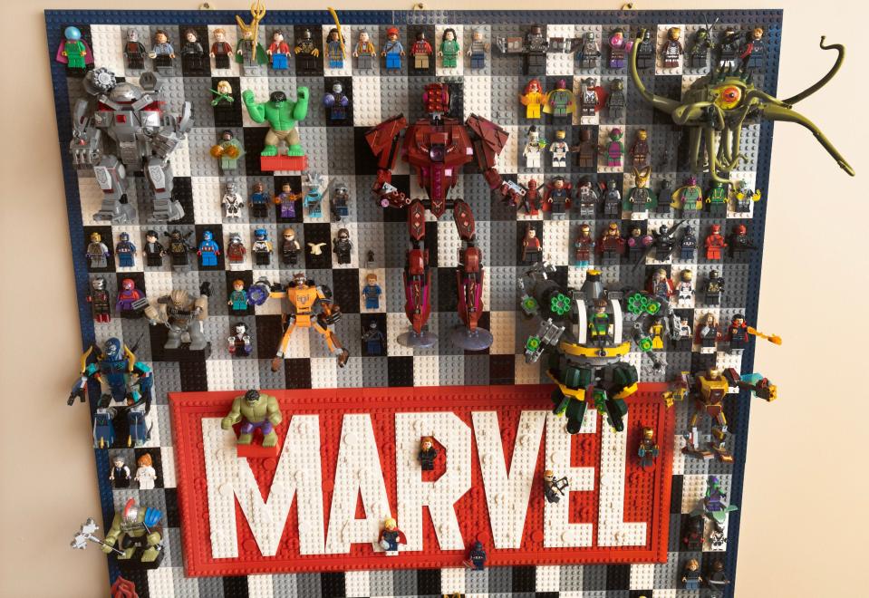 A display board on a wall in Scott Brown's basement in Plain Township holds the Lego version of the various members of the Marvel Universe.