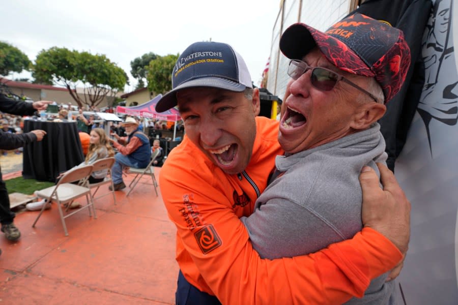 Travis Gienger of Anoka, Minn., left, reacts after winning the Safeway 50th annual World Championship Pumpkin Weigh-Off in Half Moon Bay, Calif., Monday, Oct. 9, 2023. Gienger won the event with a pumpkin weighing 2749 pounds. (AP Photo/Eric Risberg)