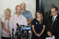 Jim Schmidt, center left, stepfather of Gabby Petito, whose death on a cross-country trip has sparked a manhunt for her boyfriend Brian Laundrie, speaks alongside Joseph Petito, father, center, Nichole Schmidt, mother, center right, Tara Petito, stepmother, left, and the family attorney Richard Stafford, right, during a news conference, Tuesday, Sept. 28, 2021, in Bohemia, N.Y. (AP Photo/John Minchillo)