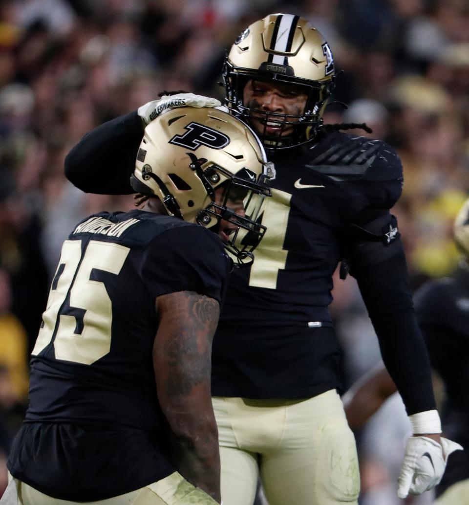 Purdue Boilermakers defensive lineman Joe Anderson (95) and Purdue Boilermakers linebacker Kydran Jenkins (4) celebrate after a defensive stop during the NCAA football game against the Minnesota Golden Gophers, Saturday, Nov. 11, 2023, at Ross-Ade Stadium in West Lafayette, Ind. Purdue Boilermakers won 49-30.