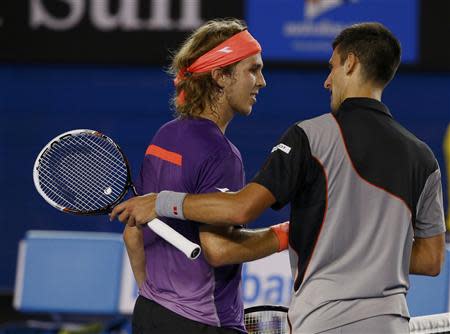 Novak Djokovic of Serbia (R) shakes hands with Lukas Lacko of Slovakia after defeating him in their men's singles match at the Australian Open 2014 tennis tournament in Melbourne January 13, 2014. REUTERS/David Gray