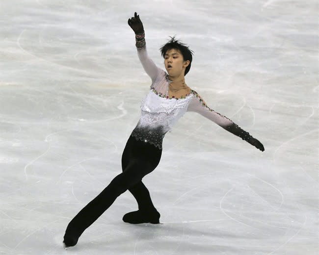 Yuzuru Hanyu of Japan performs in the men's free skating event at the ISU Figure Skating Eric Bompard Trophy, at Bercy arena in Paris, Saturday, Nov. 16, 2013. (AP Photo/Michel Euler)