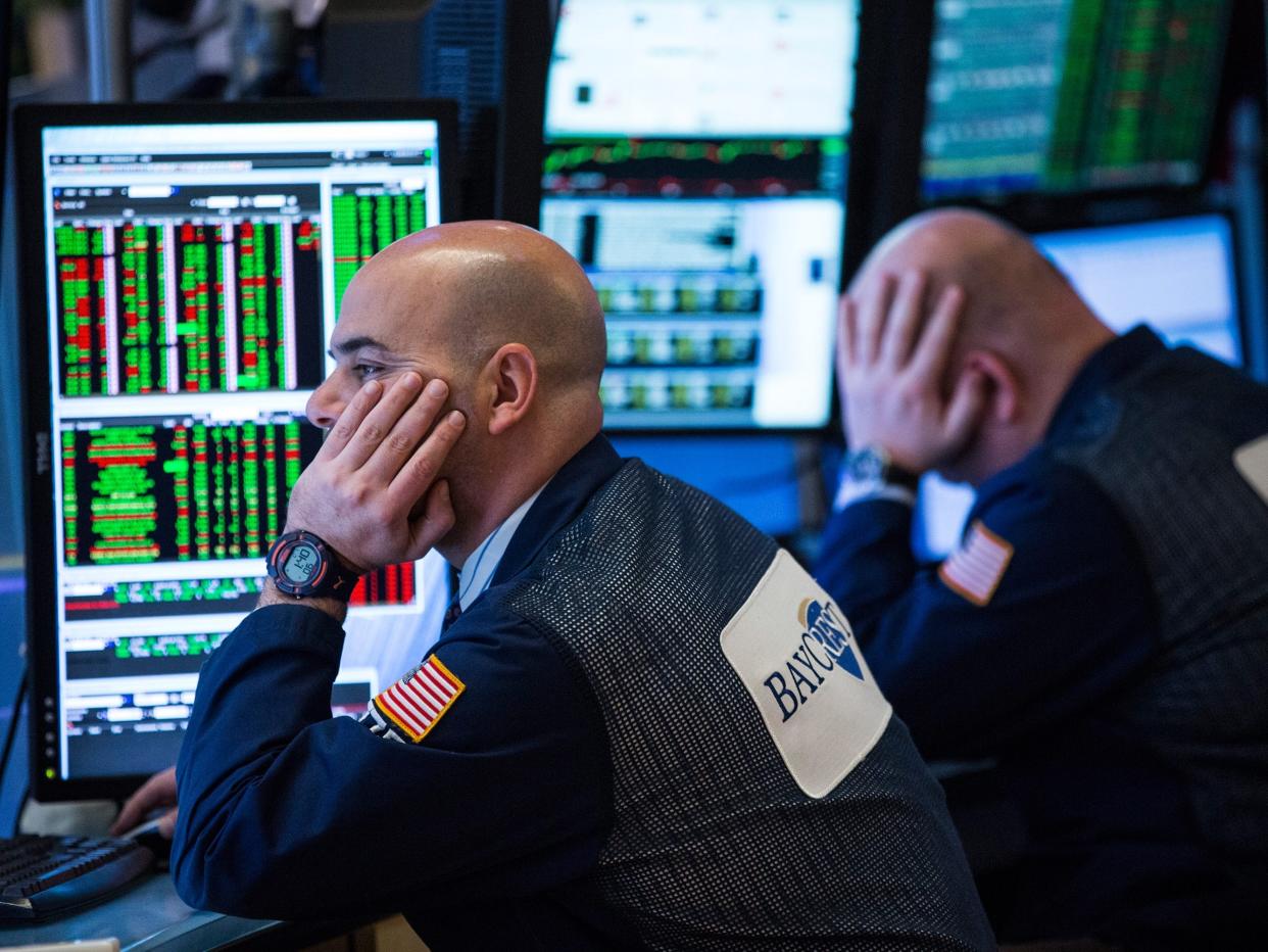 Traders on the floor of the New York Stock Exchange wait to learn if the Federal Reserve will raise interest rates during the afternoon of January 27, 2016 in New York City