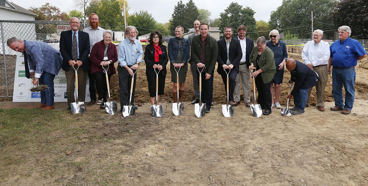 The Bridge Home Executive Director Jodi Stumbo (center), Mayor of Ames John Haila, and other dignitaries participate in the groundbreaking ceremony of the new Bridge Home building on Wednesday.