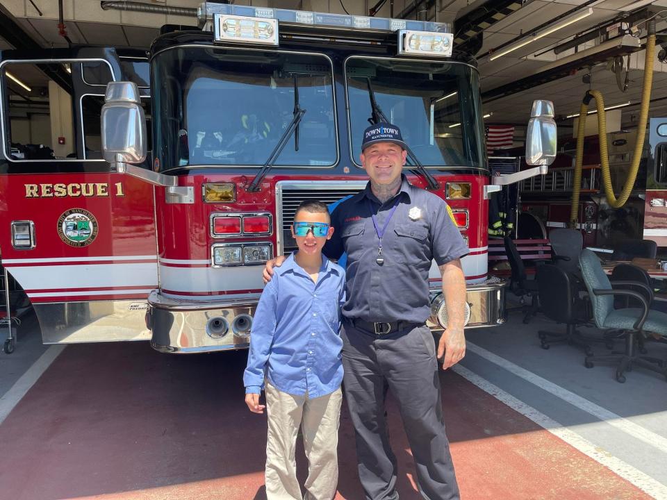 Dartmouth Health Children’s Buddy Izayiah visits his Badges Baseball player, Manchester firefighter Adam Langlois, for a tour of the fire station.