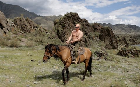 Mr Putin rides a horse shirtless during a 2009 holiday in Siberia - Credit: Alexey Druzhinin/AFP/Getty