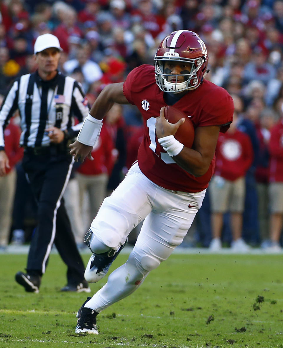 Alabama quarterback Tua Tagovailoa (13) scrambles for yardage during the first half of an NCAA college football game against Mississippi State, Saturday, Nov. 10, 2018, in Tuscaloosa, Ala. (AP Photo/Butch Dill)