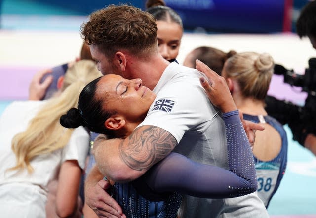 Becky Downie is given a comforting hug after he display. 