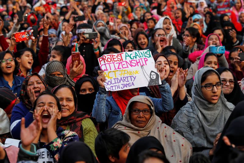 Demonstrators attend a protest against a new citizenship law, outside the Jamia Millia Islamia university in New Delhi