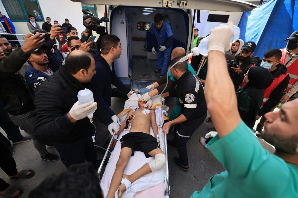 Medics care for injured Palestinians after IDF forces bombarded a hospital in Rafah.