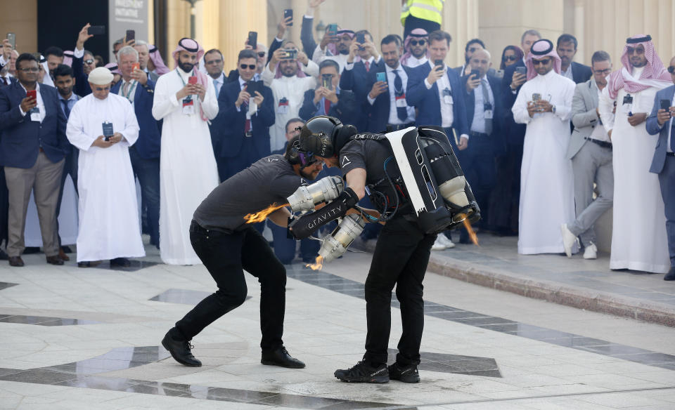 British inventor Richard Browning prepares to fly using a jet pack to display his technology at the Future Investment Initiative forum in Riyadh, Saudi Arabia, Tuesday, Oct. 29, 2019. The long-planned initial public offering of a sliver of Saudi Arabia's state-run oil giant Saudi Aramco will see shares traded on Riyadh's stock exchange in December, a Saudi-owned satellite news channel reported Tuesday as the kingdom's marquee investment forum got underway. (AP Photo/Amr Nabil)