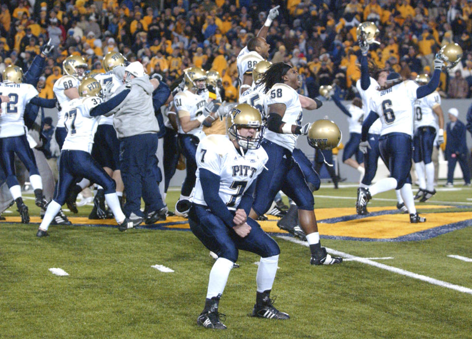 FILE - Pittsburgh's Steve Malinchak (7) and teammates celebrate their 13-9 upset win over No. 2 West Virginia in an NCAA college football game Dec. 1, 2007, in Morgantown, W.Va. The rivalry between the longtime rivals will be renewed following an 11-year hiatus on Thursday, Sept. 1, 2022, when the 17th-ranked Panthers host the Mountaineers. (AP Photo/Jeff Gentner, File)