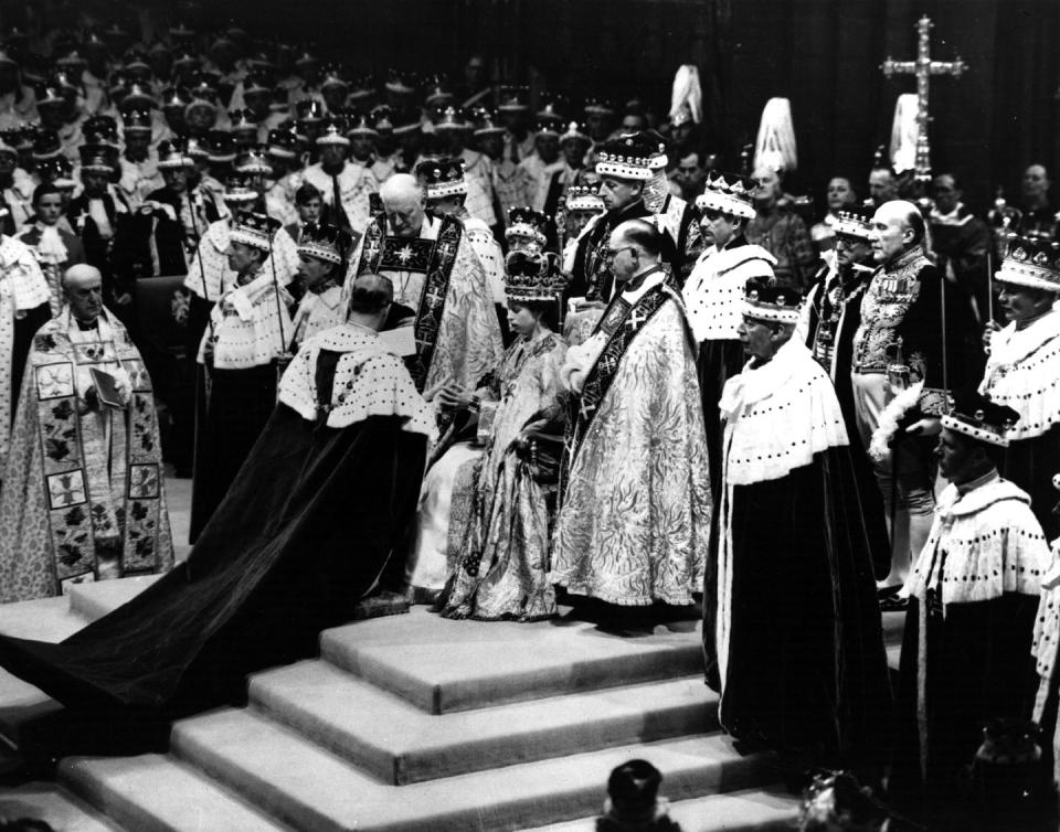 the duke of edinburgh pays homage to queen elizabeth ii during her coronation photo by fox photosgetty images