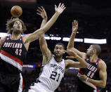 Portland Trail Blazers' Robin Lopez (42) and Nicolas Batum (88) battle with San Antonio Spurs' Tim Duncan (21) for a rebound during the first half of Game 1 of a Western Conference semifinal NBA basketball playoff series, Tuesday, May 6, 2014, in San Antonio. (AP Photo/Eric Gay)