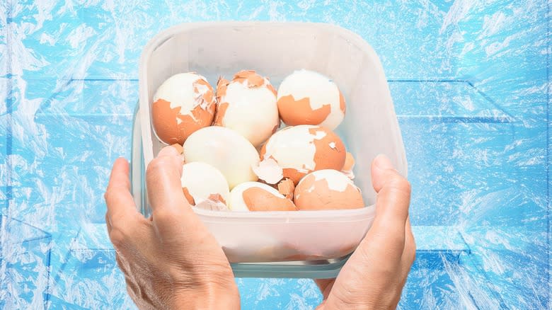 Hands placing eggs into freezer 