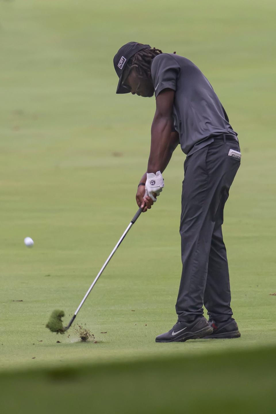 Ajani Johnson takes a divot on his approach shot on the 9th hole it at the Men's City Golf Tournament, presented by the Bob Rohrman Auto Group, Sunday Jul. 17, 2022 in West Lafayette.