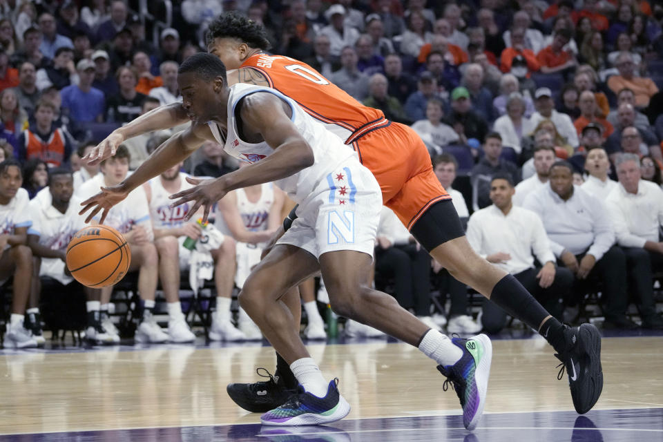 Northwestern guard Chase Audige, left, and Illinois guard Terrence Shannon Jr., battle for a loose ball during the first half of an NCAA college basketball game in Evanston, Ill., Wednesday, Jan. 4, 2023. (AP Photo/Nam Y. Huh)