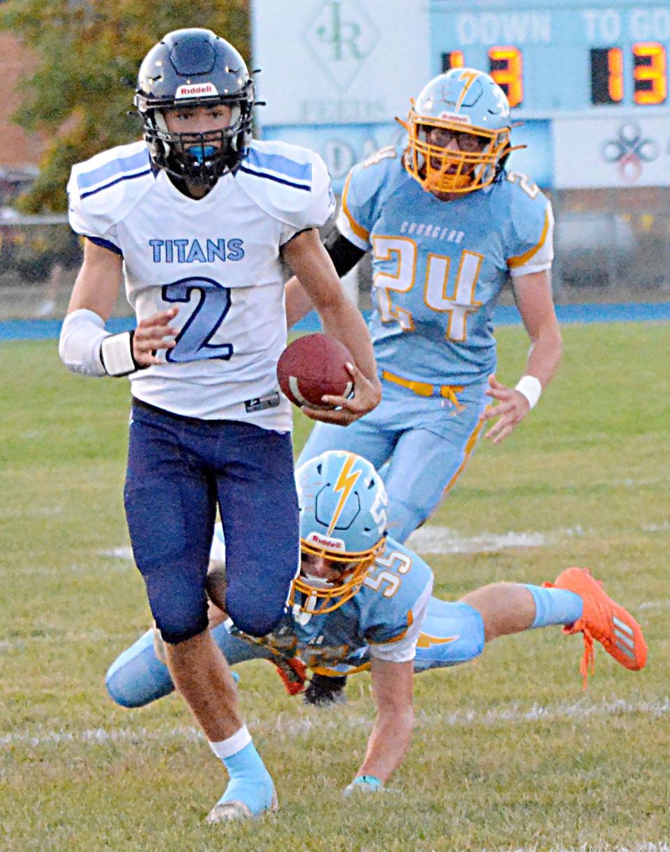 Leola-Frederick Area quarterback Brayden Sumption scrambles away from Hamlin's Kadyn Swenson (55) and Kaden St.Pierre during their high school football game in 2022. (Public Opinion photo by Roger Merriam)
