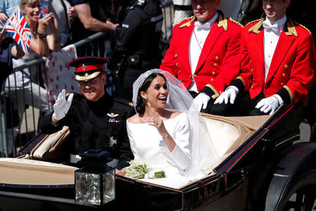 Britain’s Prince Harry and his wife Meghan ride a horse-drawn carriage after their wedding ceremony at St George’s Chapel in Windsor Castle in Windsor, Britain, May 19, 2018. REUTERS/Benoit Tessier