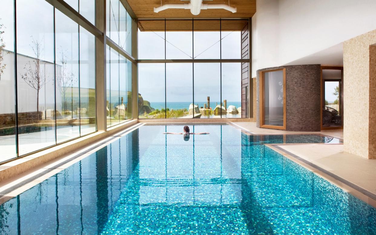 The glass-walled indoor pool at The Scarlet looks straight out to sea, providing a much-needed nook of tranquility