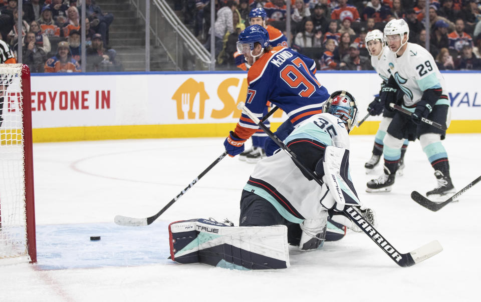 Seattle Kraken goalie Joey Daccord (35) is scored on by Edmonton Oilers' Connor McDavid (97) during the second period of an NHL hockey game, Wednesday, Nov. 15, 2023 in Edmonton, Alberta. (Jason Franson/The Canadian Press via AP)
