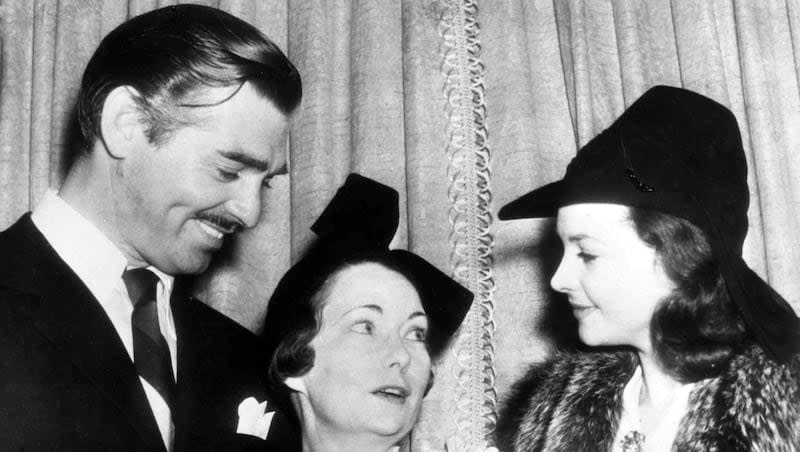 Undated photo of American author Margaret Mitchell, center, who wrote "Gone With The Wind," talking with British actress Vivien Leigh, who played Scarlett O'Hara in the film adaption of the book. American film actor Clark Gable, who played  Rhett Butler in the film, listens to the conversation.