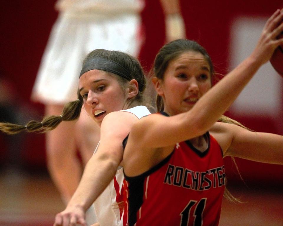 Chatham Glenwood's Karley Hawkins (left) fights for the ball against Rochester's Alaina Stock during January's Central State Eight matchup between the teams. Hawkins has overcome a blood infection that kept her from walking for months to be a standout two-sport athlete for the Titans.