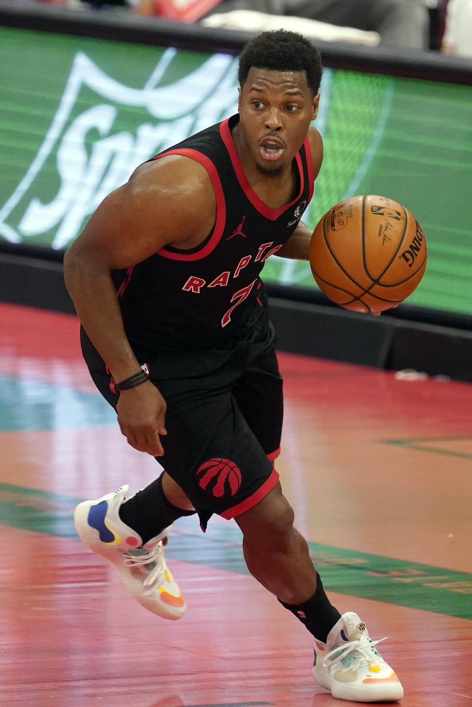 Toronto Raptors guard Kyle Lowry (7) works the ball up the floor during the second half of an NBA basketball game against the Dallas Mavericks Monday, Jan. 18, 2021, in Tampa, Fla. (AP Photo/Chris O'Meara)