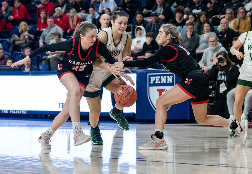 Archbishop Carroll's Maddie McFillian (25) and Alexis Eberz (12) try to get the ball from Archbishop Wood's Emily Knouse (30) during the Philadelphia Catholic League girls' basketball championship game in Philadelphia on Monday, Feb. 26, 2024.